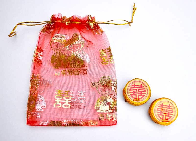 pu-erh tea in red organza favor bag